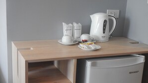 A kitchenette with a coffee maker, a kettle, a cup, and a plate with Lipton tea bags. - Bay Window at Sea (Cha-am)