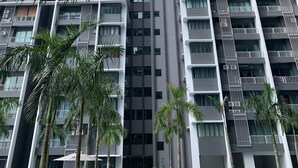 A high-rise residential building with multiple balconies, air conditioning units, and a central vertical structure. - Almyra Serviced Residence (Kajang)
