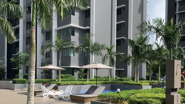 A modern hotel with a swimming pool, lounge chairs, and palm trees. - Almyra Serviced Residence (Kajang)