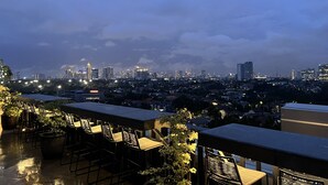 Une terrasse sur le toit, dotée d’un espace extérieur aménagé et offrant une vue panoramique sur la ville.