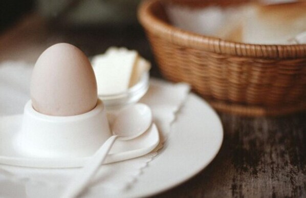 A kitchen setting with a bowl of eggs, a plate with a knife, and a basket of bread. - Hangzhou Tianyuan Tower Hotel (Hangzhou)