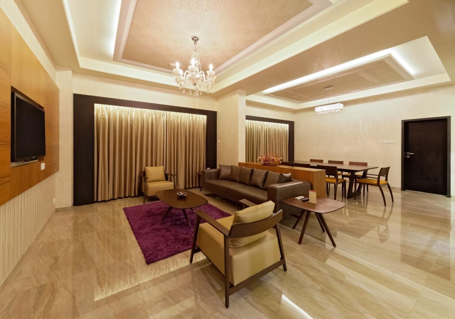 A modern living room with a sofa set, a coffee table, and a dining area with a table and chairs.