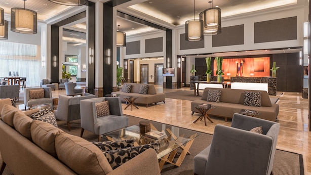 A spacious lobby with multiple seating areas, a reception desk, and modern lighting fixtures. - Seda Ayala Center Cebu City (Cebu City)