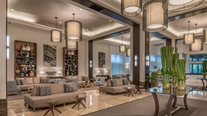 A spacious lobby with a modern design, featuring a large seating area with sofas and armchairs, a glass coffee table, and a decorative vase with plants. - Seda Ayala Center Cebu City (Cebu City)