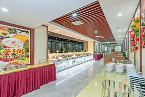 Enjoy a variety of dishes at our central buffet, offering a range of options for a convenient dining experience.