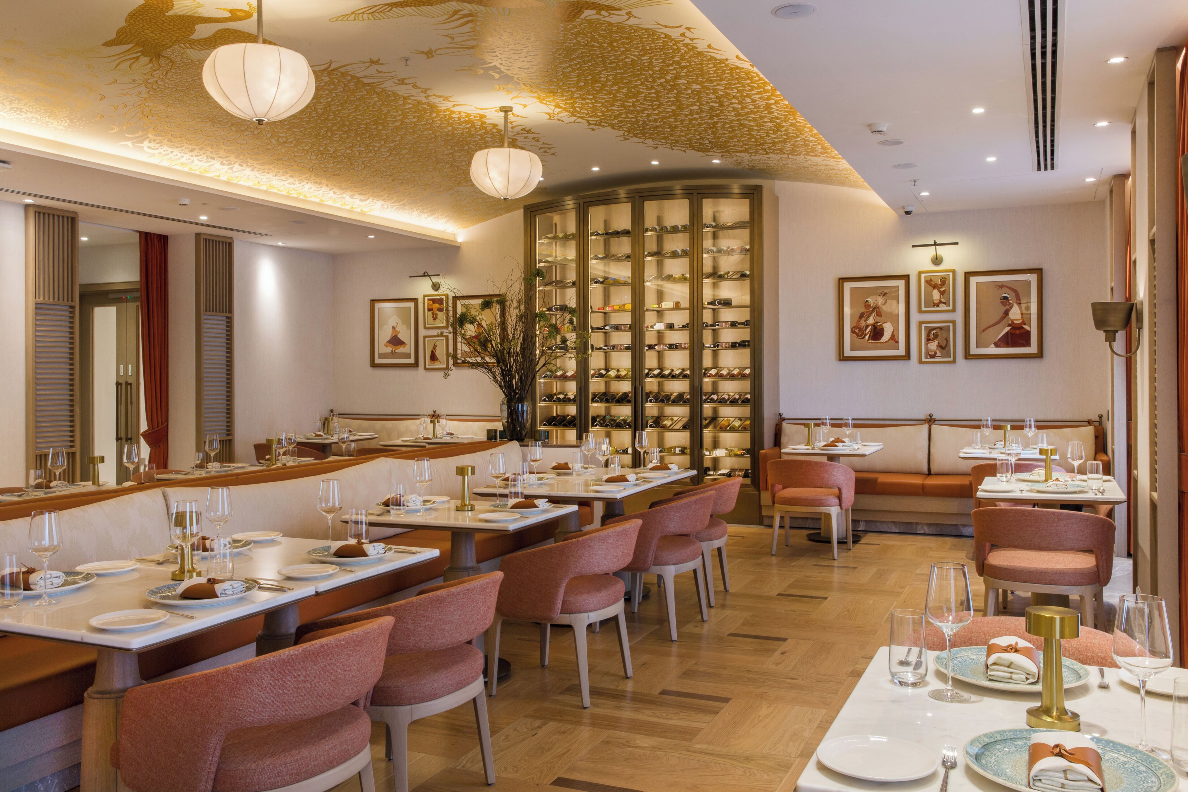 A restaurant with multiple dining tables, chairs, and a wine rack.
