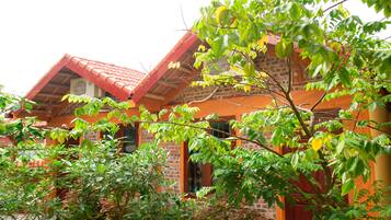 A traditional building with a red-tiled roof, brick walls, and a wooden facade.