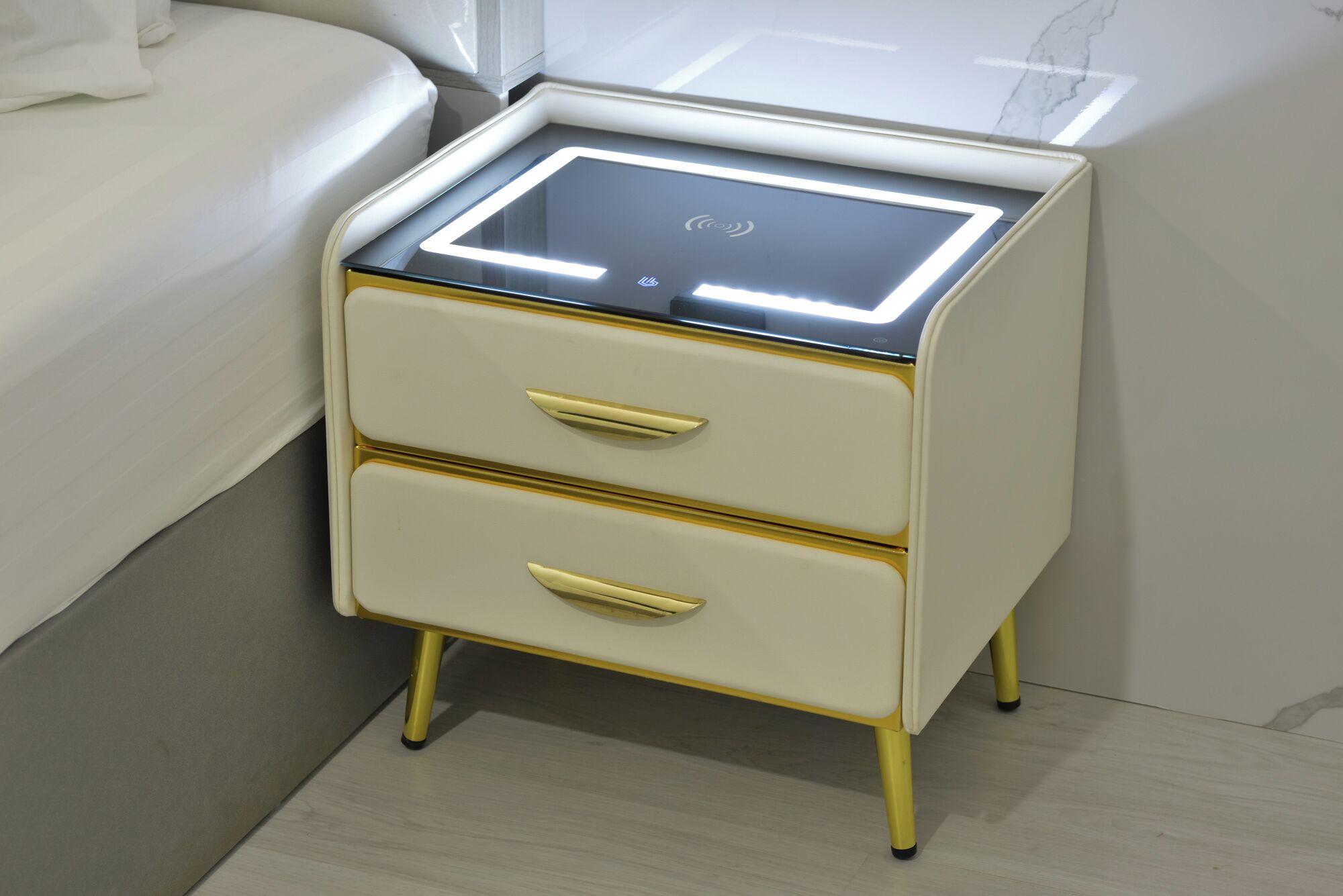 A bedside table with a built-in illuminated panel and two drawers.