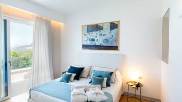 A bedroom with a bed, a painting, a nightstand, and a view through a window.