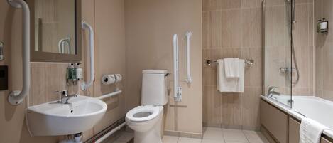 Ein modernes Badezimmer mit Waschbecken, Toilette und Badewanne.
