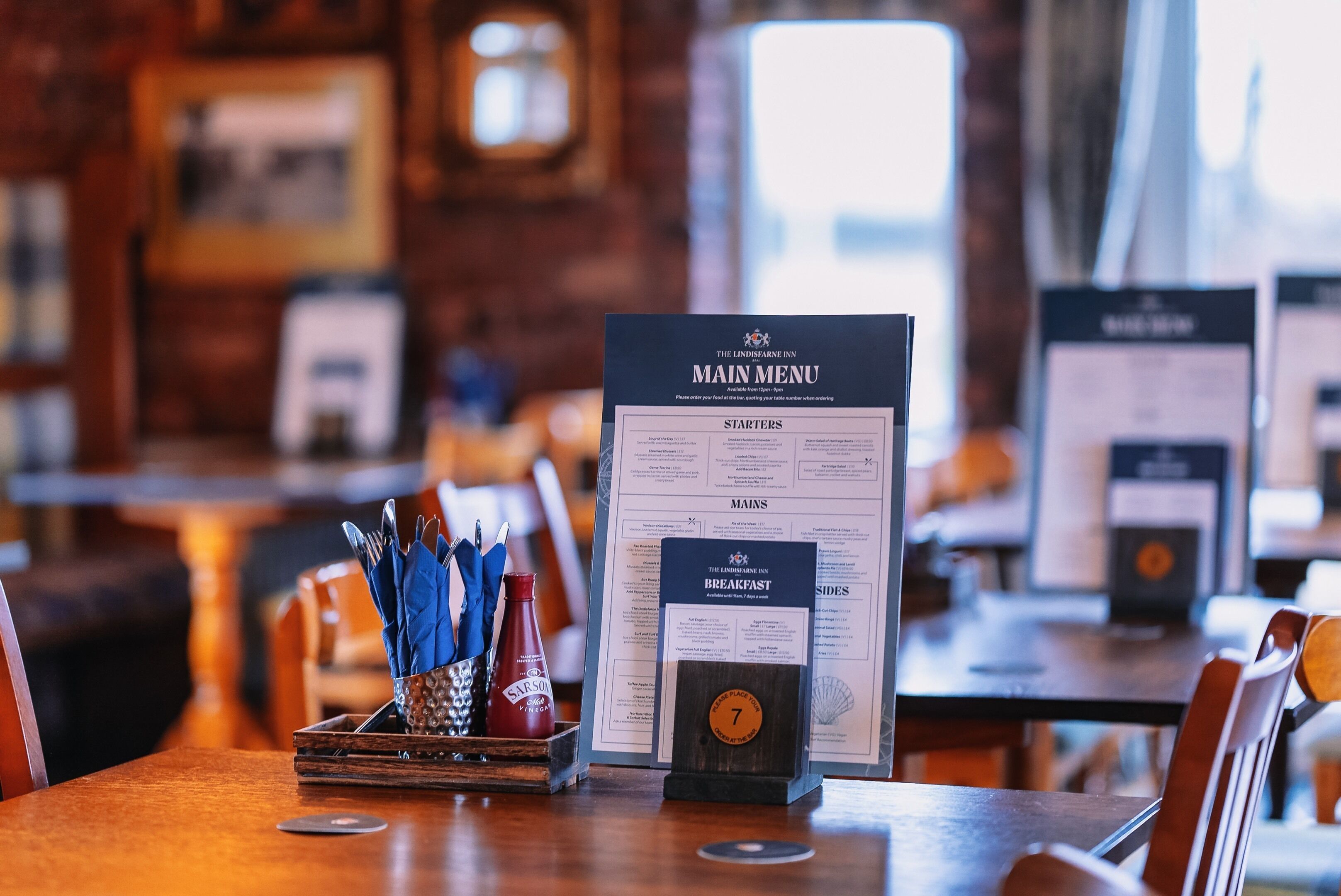 A restaurant menu with a wooden frame and a number 7 badge.