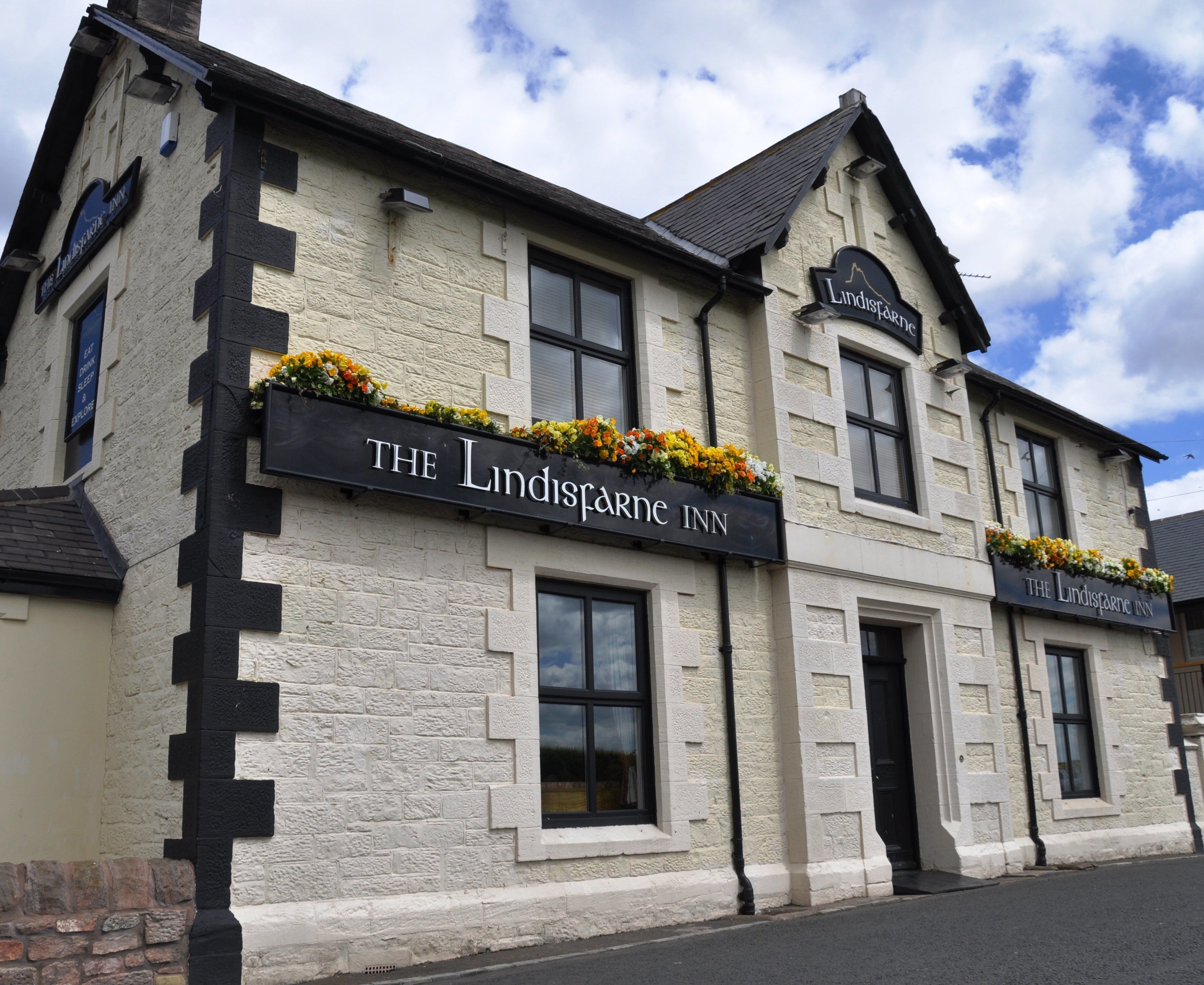 A building with a sign reading "The Lindisfarne Inn."