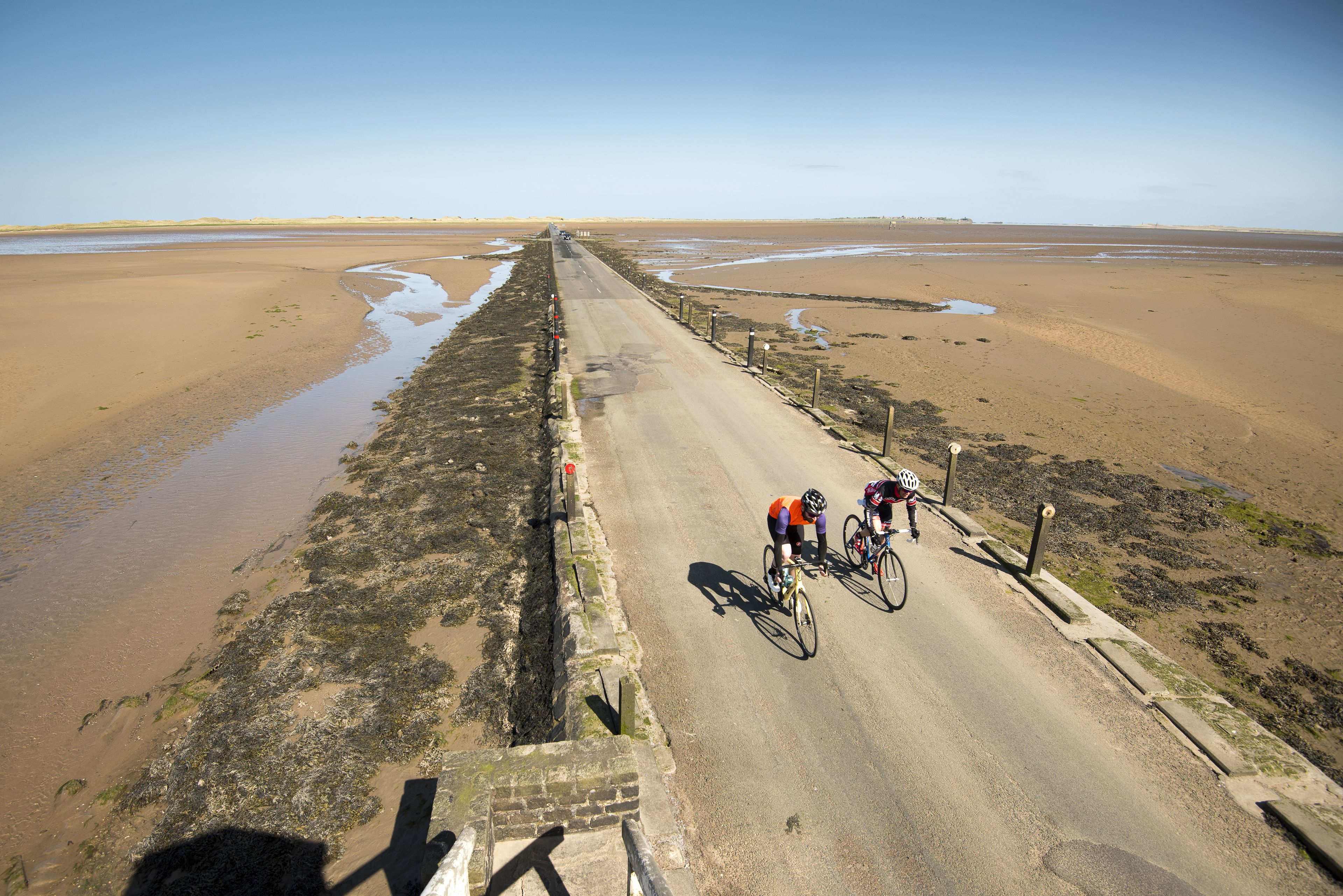 A coastal road with cyclists.