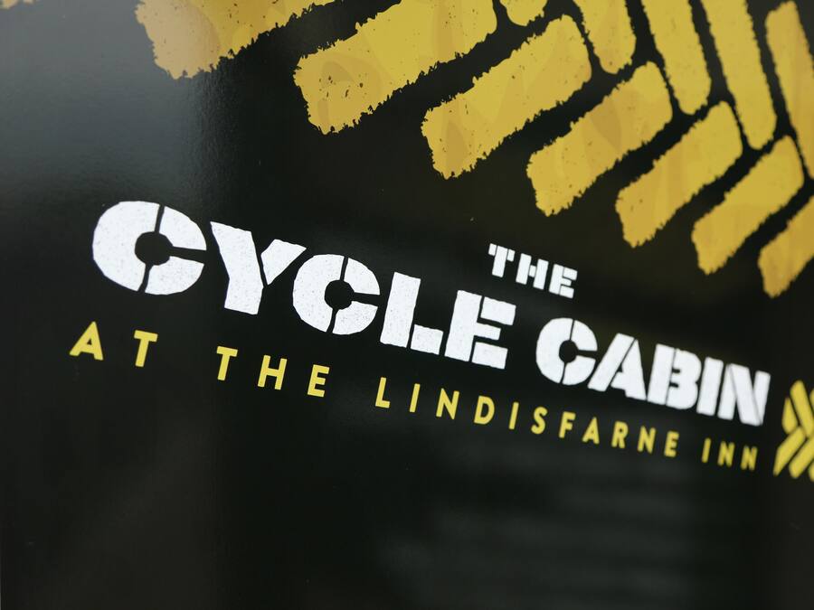 Un logotipo con el texto 'The Cycle Cabin at The Lindisfarne Inn'.