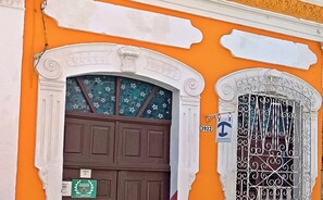 Stunning building facade with a classical architectural style, featuring a decorative arch and ornate details.