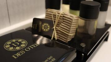 A black tray with a black box labeled 'DES' OTEI' and several black bottles.