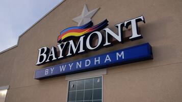 A sign for a hotel named 'Baymont By Wyndham'.