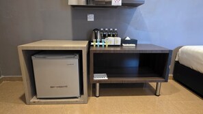 A compact kitchenette with a mini-fridge, a coffee maker, and a bottle of hand soap. - Kampar Boutique Hotel (Kampar)