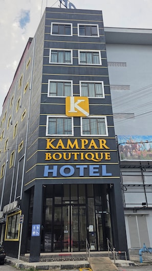 A hotel with a prominent sign for 'KAMPAR BOUTIQUE HOTEL' and a large 'K' logo. - Kampar Boutique Hotel (Kampar)
