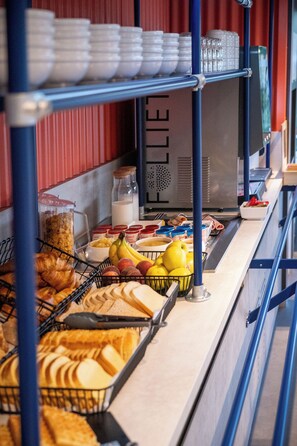 A buffet setup with various food items and condiments.