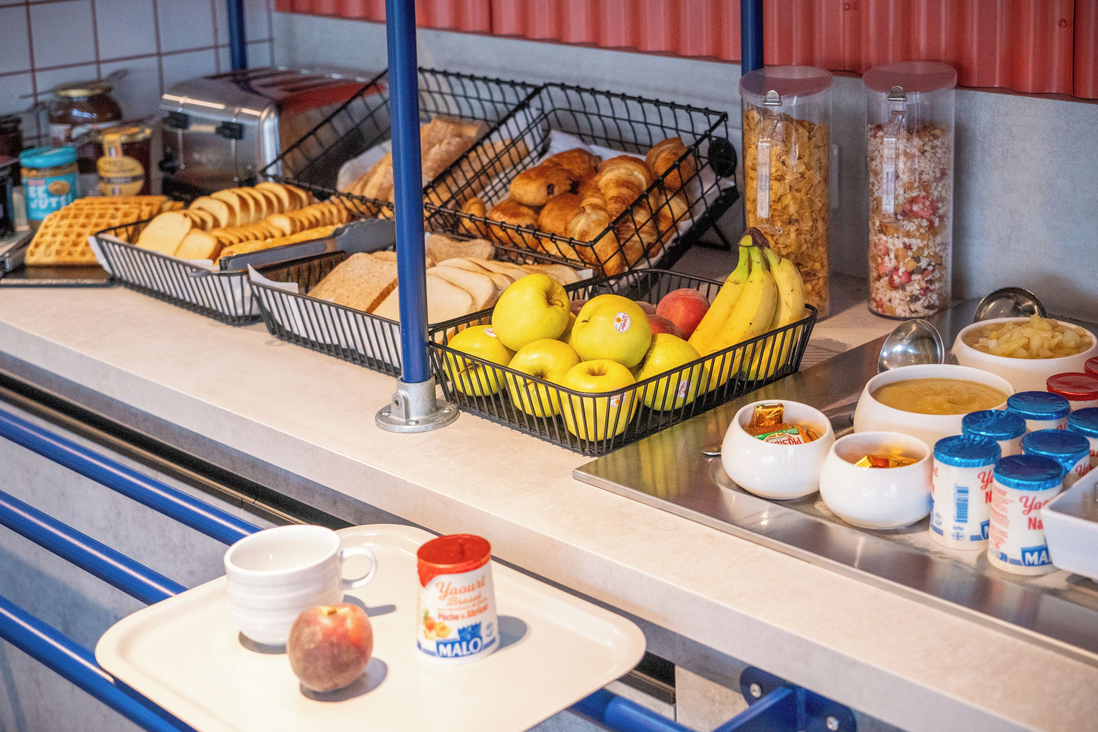 A breakfast buffet with various food items and condiments.