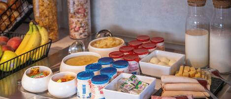 A breakfast buffet with various food items and condiments.