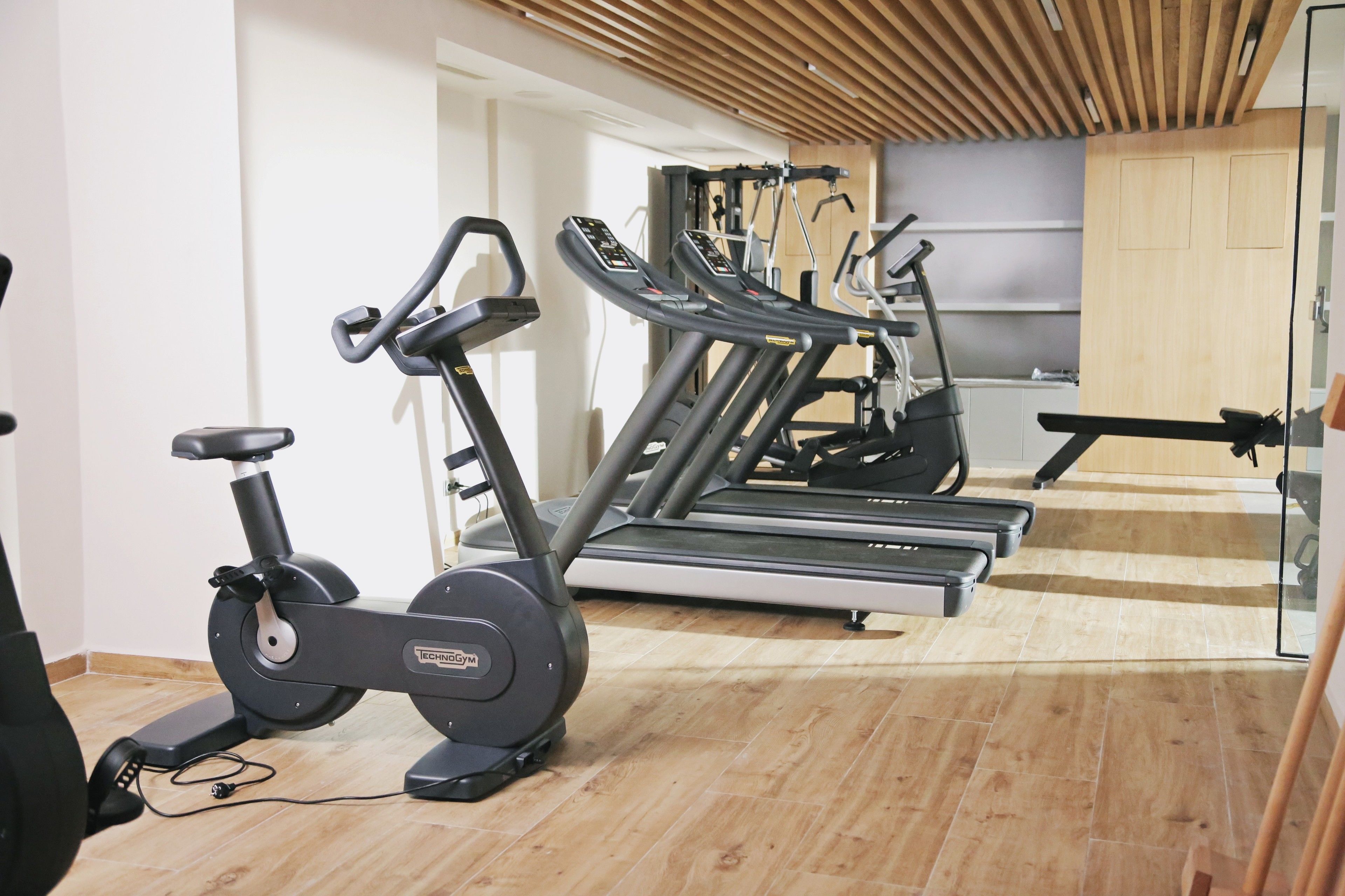 A gym with stationary bikes, treadmills, and exercise equipment.