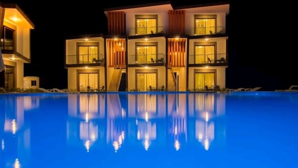A multi-story hotel with a swimming pool in the foreground. - Caribbean Diamond Boutique Hotel (Sosúa)