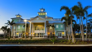 A large, multi-story hotel with a central entrance, multiple wings, and a clock tower. - New House, Near Disney, Private Pool (Kissimmee)