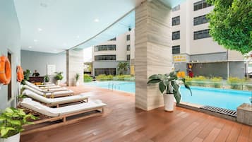 Outdoor pool, open 6:00 AM to 10:00 PM, pool loungers