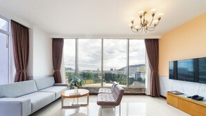 A modern living room with a sofa, a coffee table, and a TV. - DIC Star Landmark Vung Tau (Ho Chi Minh City)
