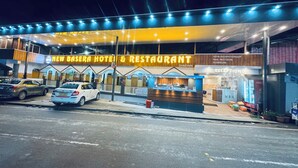 A hotel with a reception area, a dining section, and a Coca-Cola refrigerator. - New Basera Hotel (Ukhimath)