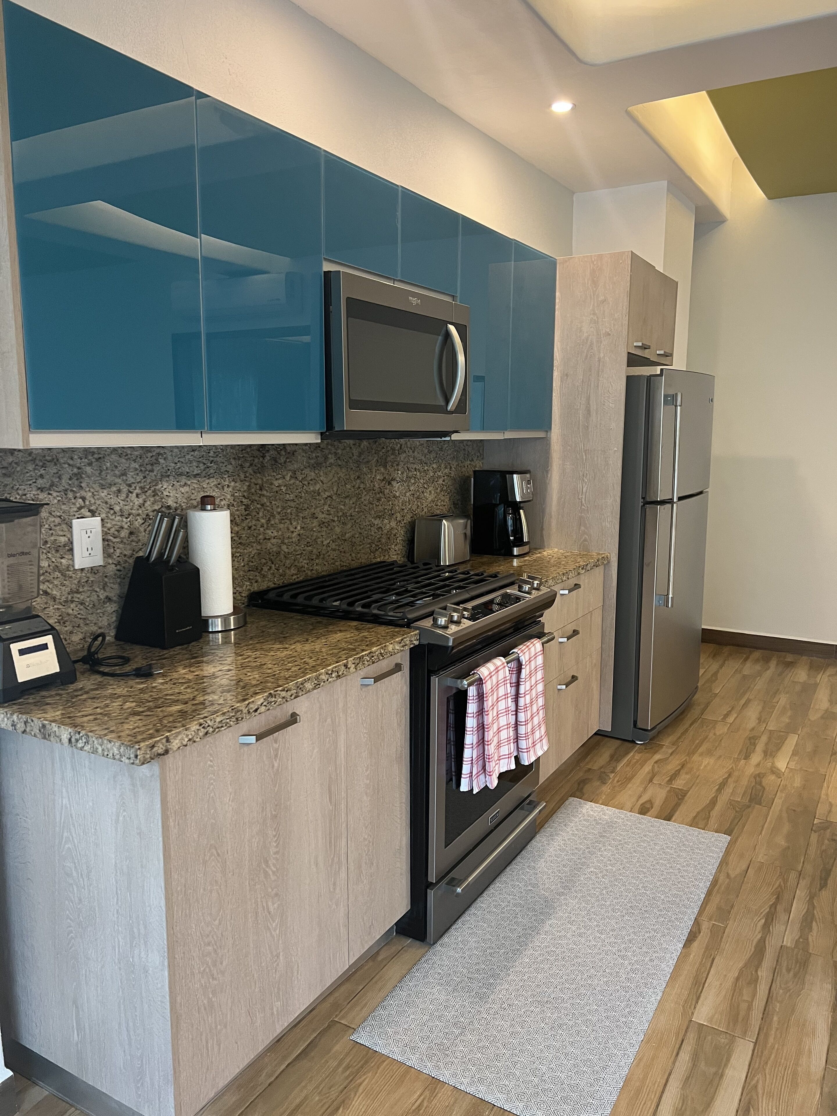 A modern kitchen with a built-in microwave, stove, and refrigerator.