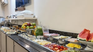 A buffet with a variety of food items including fruits, cheeses, and meats. - Hotel Dom Rafael Premium (Santa Maria)