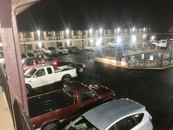 A parking lot with several cars and a building in the background.