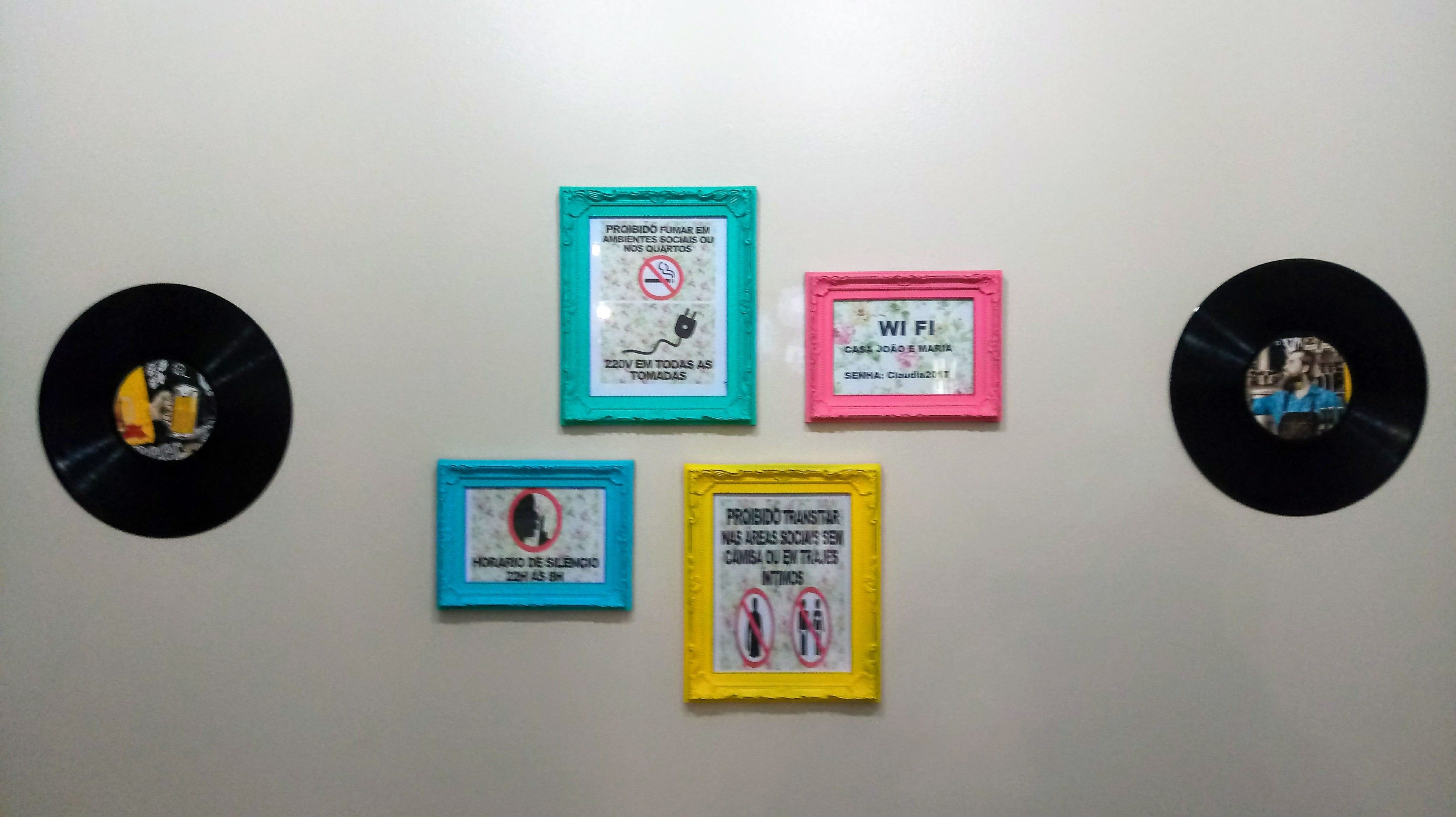 Four framed signs with text and symbols, mounted on a wall.