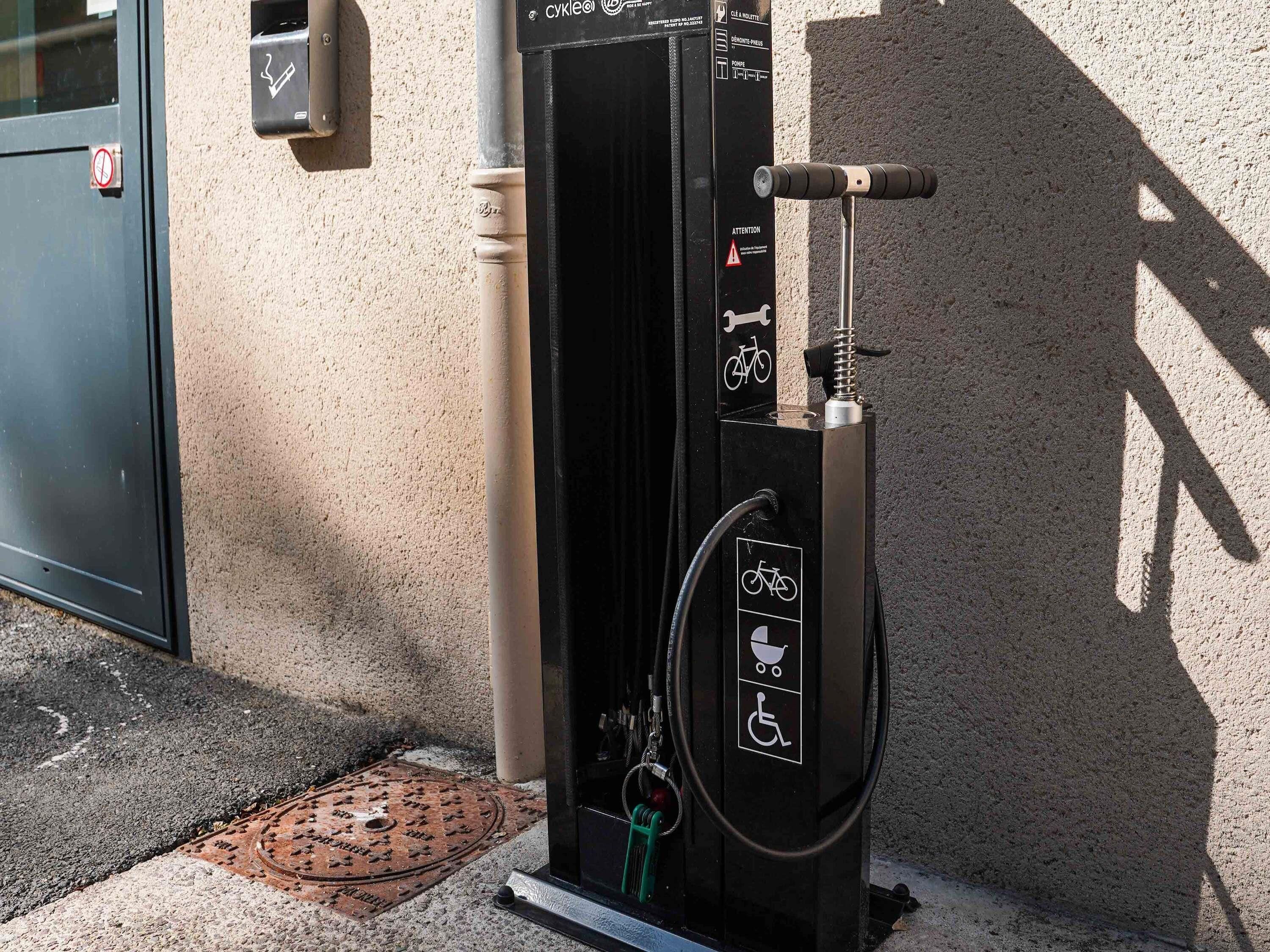 A bicycle charging station with a sign indicating it is for bicycles and electric scooters.