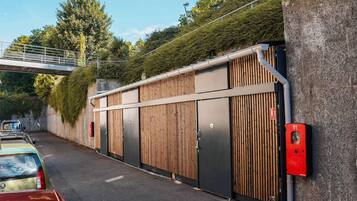 A parking garage with a modern design, featuring a covered walkway and a gated entrance.