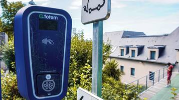 Electric vehicle charging station available on site, conveniently located near pedestrian pathways.