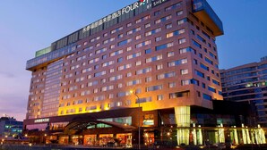 A multi-story hotel with a prominent sign reading "Four Points by Sheraton" and a large entrance with a covered walkway. - Four Points by Sheraton Beijing, Haidian (Beijing)