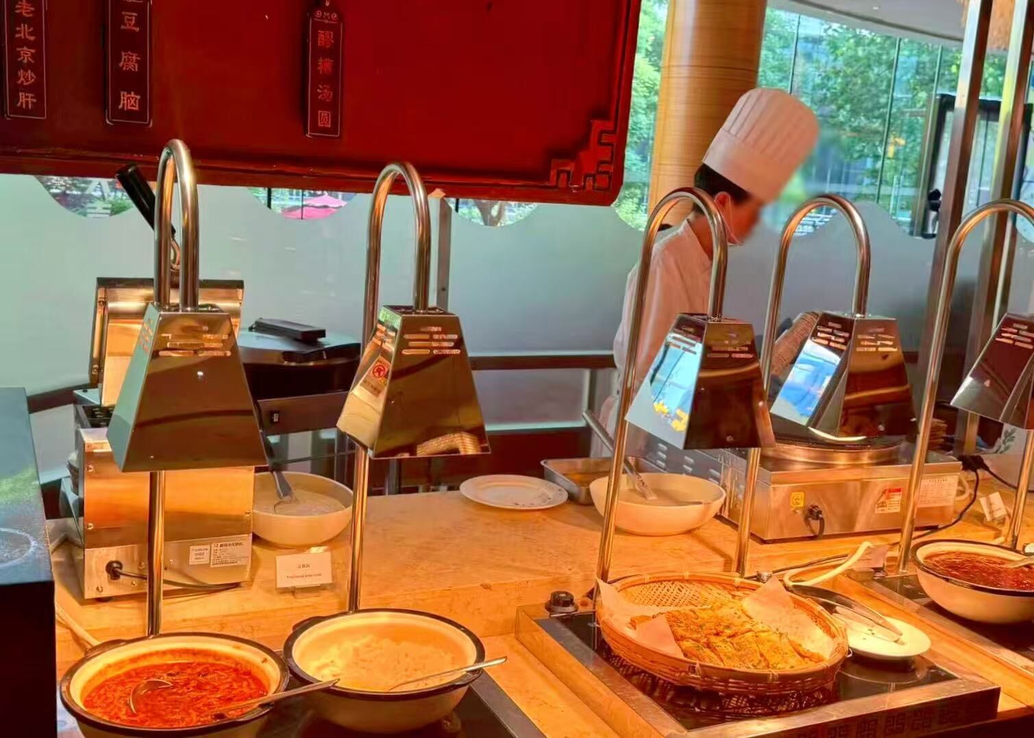 A buffet setup with multiple serving stations, each with a digital menu display.