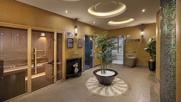 Um hall com painéis de madeira, uma planta em vaso central e piso de azulejos.