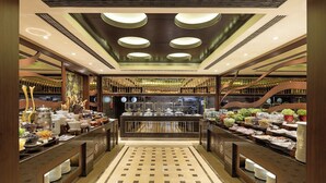 A buffet with a variety of food items and a central serving area. - Titanic City Taksim (Istanbul)