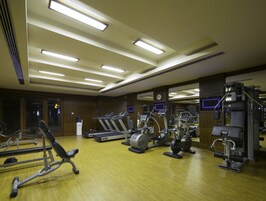 A gym with treadmills, elliptical machines, and weight equipment.