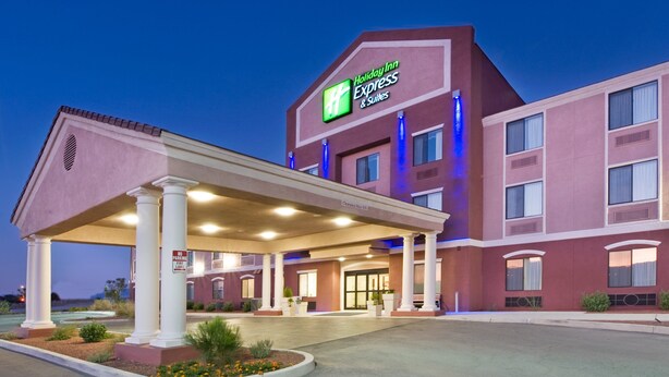 A Holiday Inn Express & Suites building with a covered entrance, columns, and a sign indicating no parking. - Holiday Inn Express & Suites Willcox by IHG (Willcox)