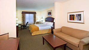 A hotel room with a bed, a sofa, a desk, and a chair. - Holiday Inn Express & Suites Willcox by IHG (Willcox)