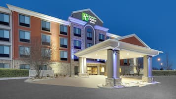 A Holiday Inn Express hotel with a covered entrance and a stone facade.