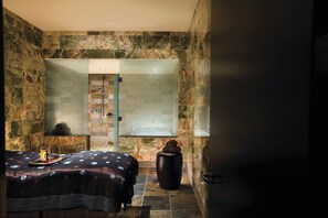 A bathroom with a shower, a bed with a polka dot bedspread, and a decorative vase. - MGM Tower at Borgata (Atlantic City)