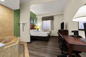 A hotel room with a bathtub, a bed, a desk, and a television. - Sleep Inn & Suites Near Joint Base Andrews - Washington Area (Upper Marlboro)