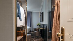 A compact hotel room with a bunk bed, a small seating area, a flat-screen TV, and a bathroom with a shower curtain. - Hotel Milano & Spa (Verona)
